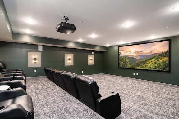 A home theater with a large screen and comfortable seating.
