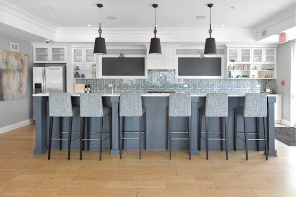 A kitchen with a bar area and stools.