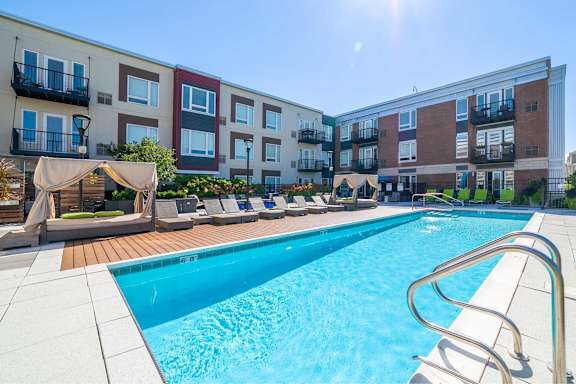 A swimming pool in front of apartment buildings.