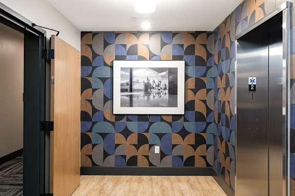 A hallway with a framed black and white photo on the wall.
