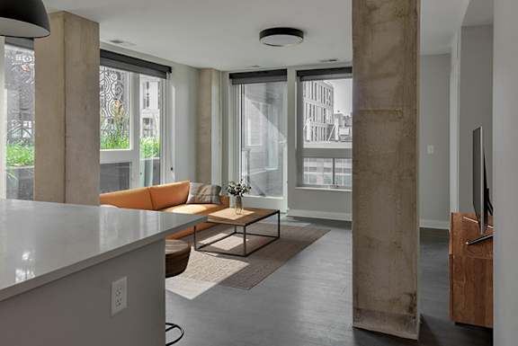 A modern living room with a large window and a couch.