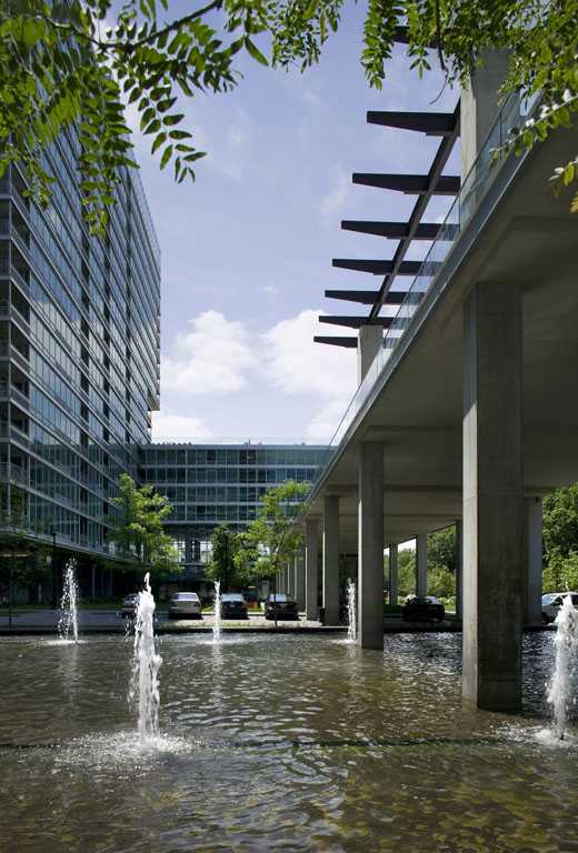 A modern building with a fountain in front of it.