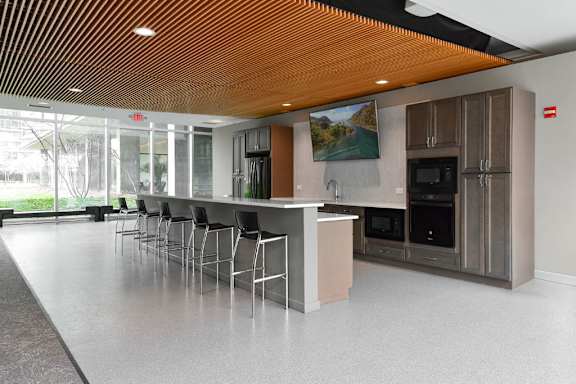 A modern kitchen with a long island and stainless steel appliances.