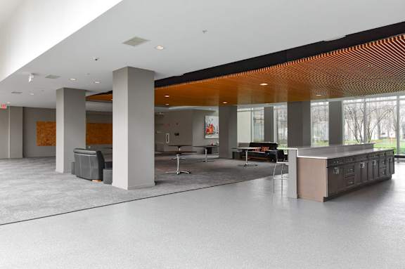 A modern office space with a long table and chairs.
