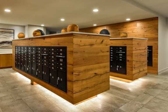 A wooden bar with black drawers and a counter.