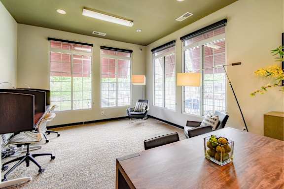 A conference room with a long table and chairs.
