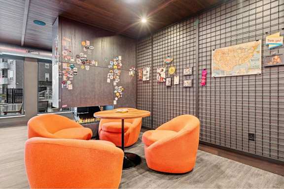 A room with orange chairs and a map on the wall.