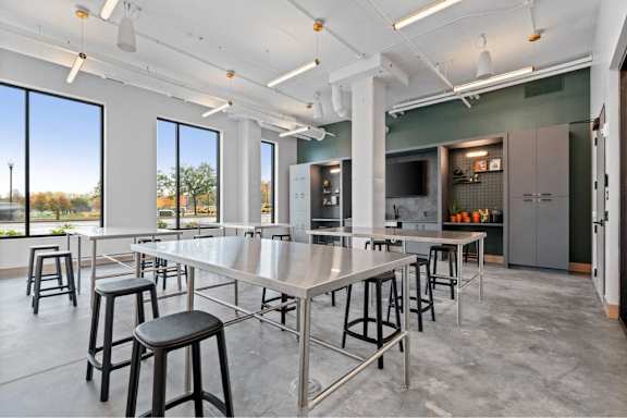 A modern dining area with a long table and chairs.