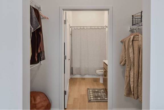 A small room with a doorway leading to a bathroom.