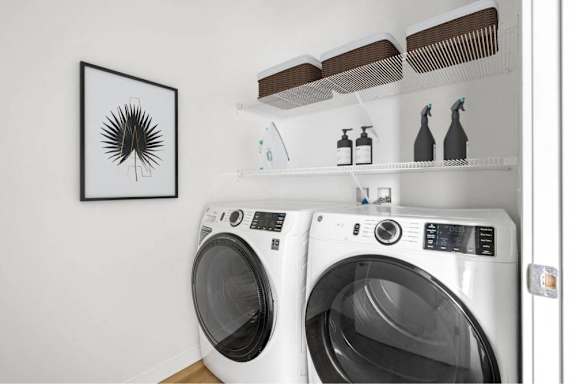Two front load washing machines in a laundry room.
