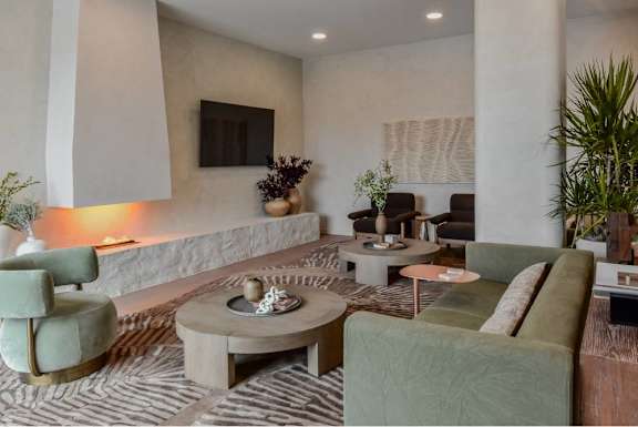 A living room with a grey sofa, a green armchair, and a coffee table.