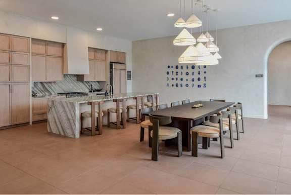 A modern kitchen with a dining table and chairs.