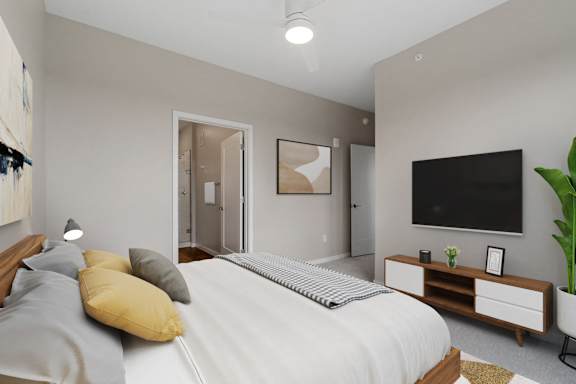 A bedroom with a bed, nightstand, and a television.