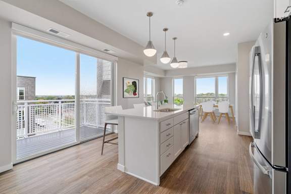 A modern kitchen with a refrigerator on the right side.