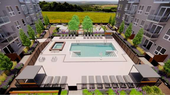 A pool surrounded by buildings and trees.