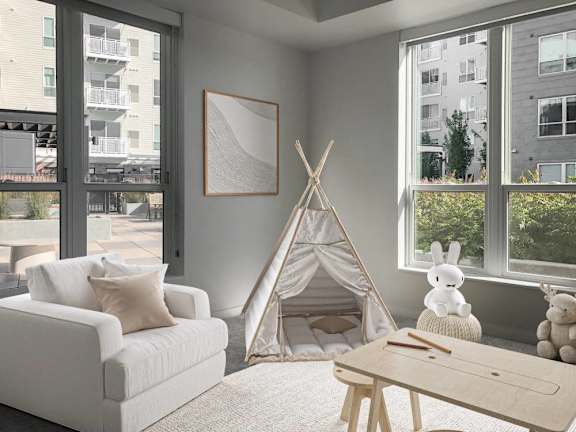 A cozy room with a teepee, a couch, and a table.
