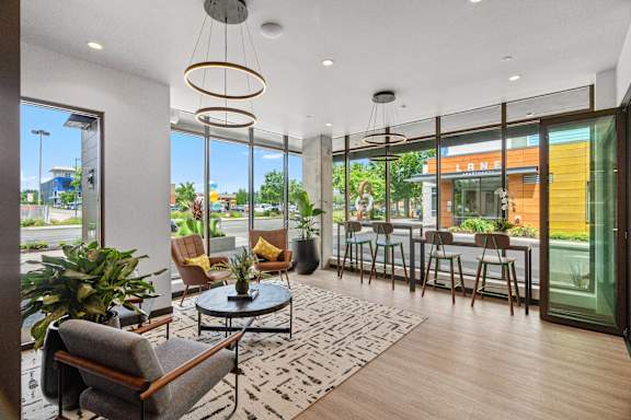 A modern living room with a glass door leading to a balcony.