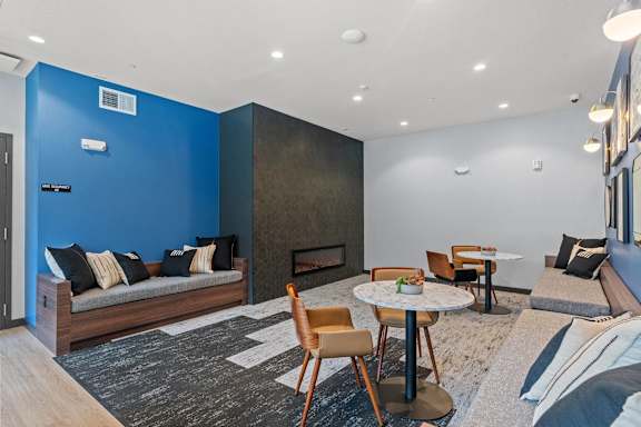 A living room with a fireplace and a blue wall.