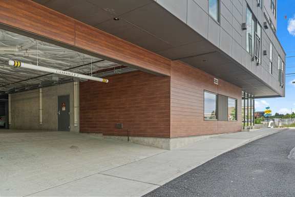 A building with a wooden facade and a garage door.