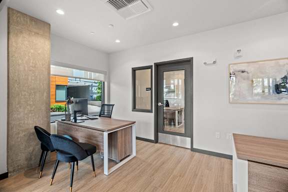 A room with a desk and a chair.