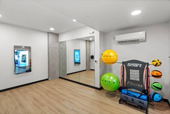 A room with a Smart Fitness ball and chair.