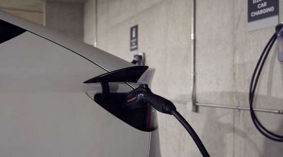 A car is plugged into a charging station.