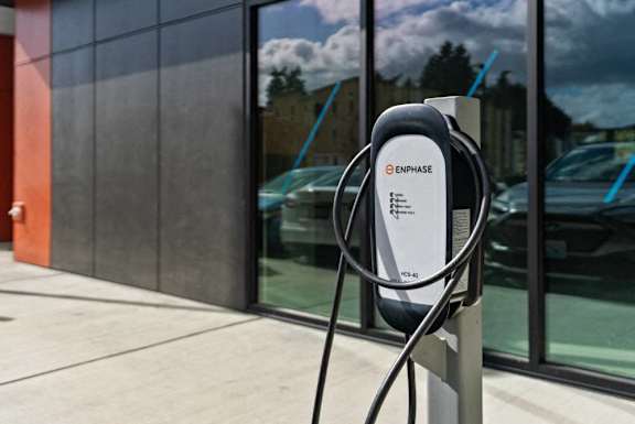 An E-Phase electric vehicle charging station is installed outside a building.