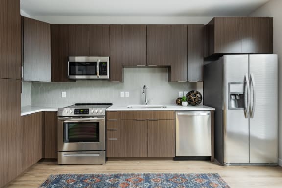 a kitchen with stainless steel appliances and wooden cabinets