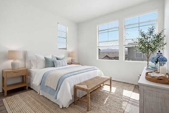 A bedroom with a large bed and a view of the city.