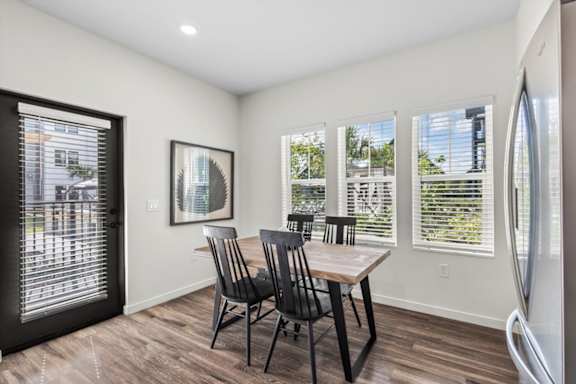 A dining room with a table and chairs.