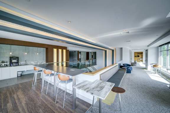 A modern kitchen with a long table and chairs.