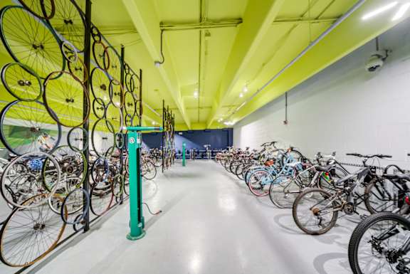 A bike shop with many bicycles hanging on the wall.