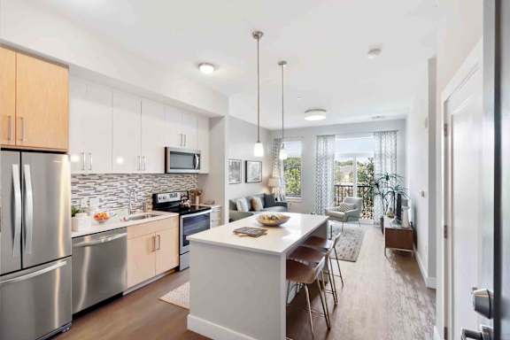 A modern kitchen with stainless steel appliances and wooden cabinets.