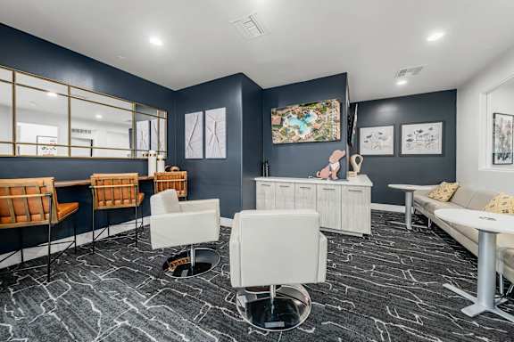 A room with a grey floor and white furniture.
