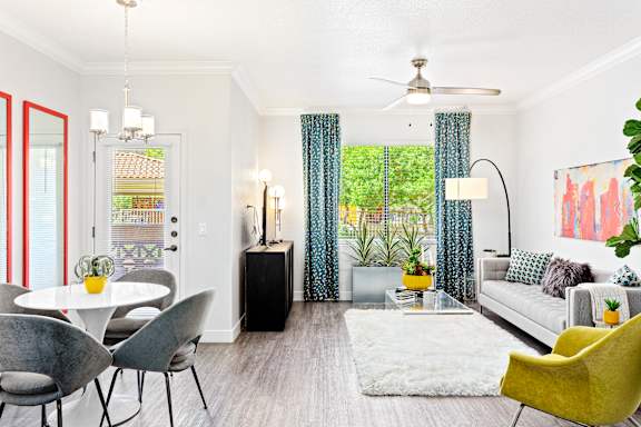 A modern living room with a dining table and chairs.