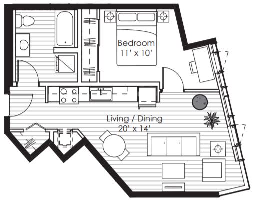 A floor plan of a room with a bedroom and living/dining area.