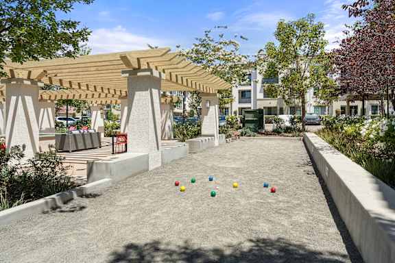 A bocce ball court next to an outdoor patio.