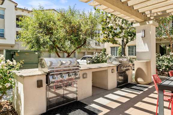A patio with grills and a table.