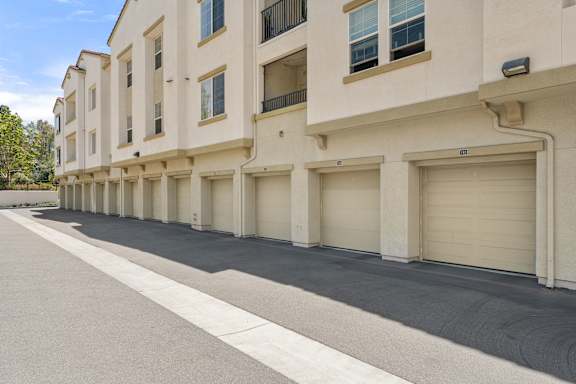 A row of beige townhouses with spacious private garages.
