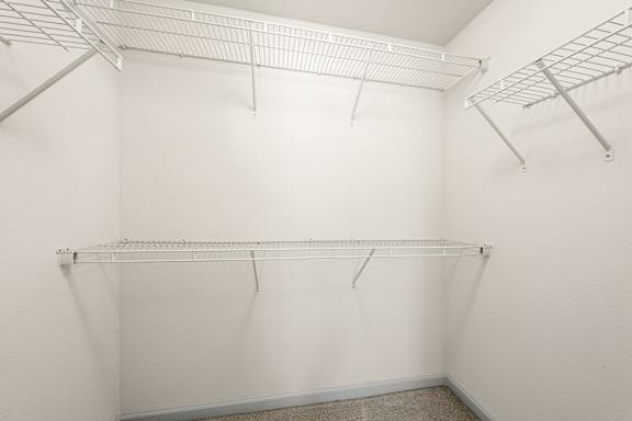 A spacious closet with built in shelving.