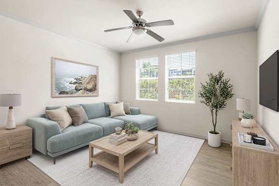 A living room with a blue couch, a wooden coffee table, and high ceilings.