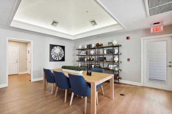 a dining room with a wooden table and blue chairs