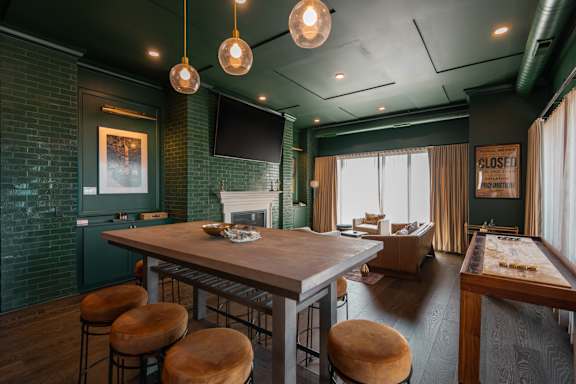 A room with a bar and a pool table.