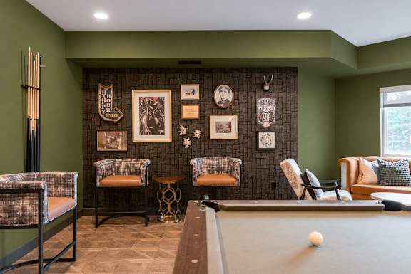 A living room with a fireplace and a television above it.