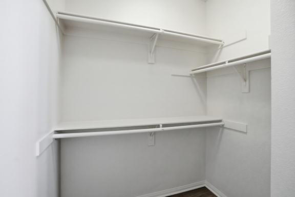 Empty white shelves in a room.
