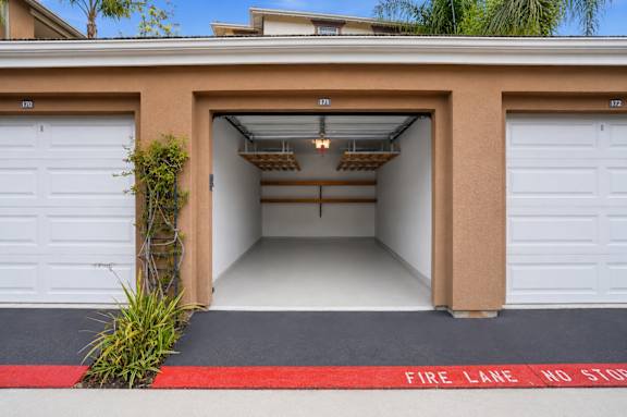 A garage with a red fire lane no stop sign.