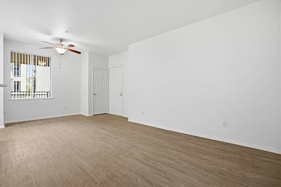 Empty room with wooden floor and white walls.