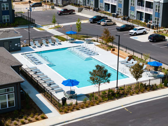 an aerial view of a swimming pool in a parking lot