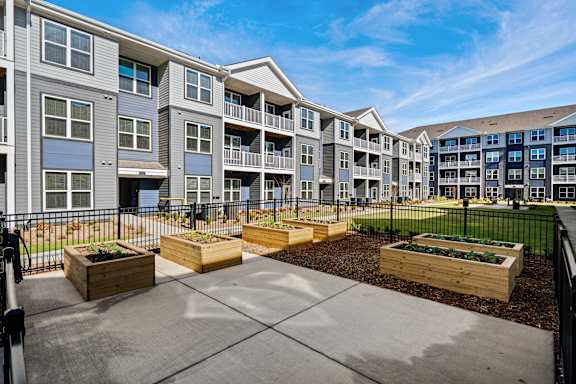 Apartment complex with a courtyard and planters.
