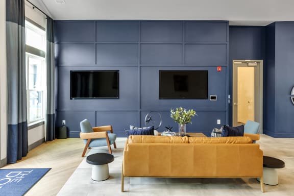 a living room with blue walls and a yellow couch